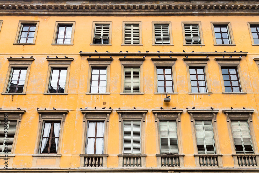 yellow facade of old apartment house in Florence