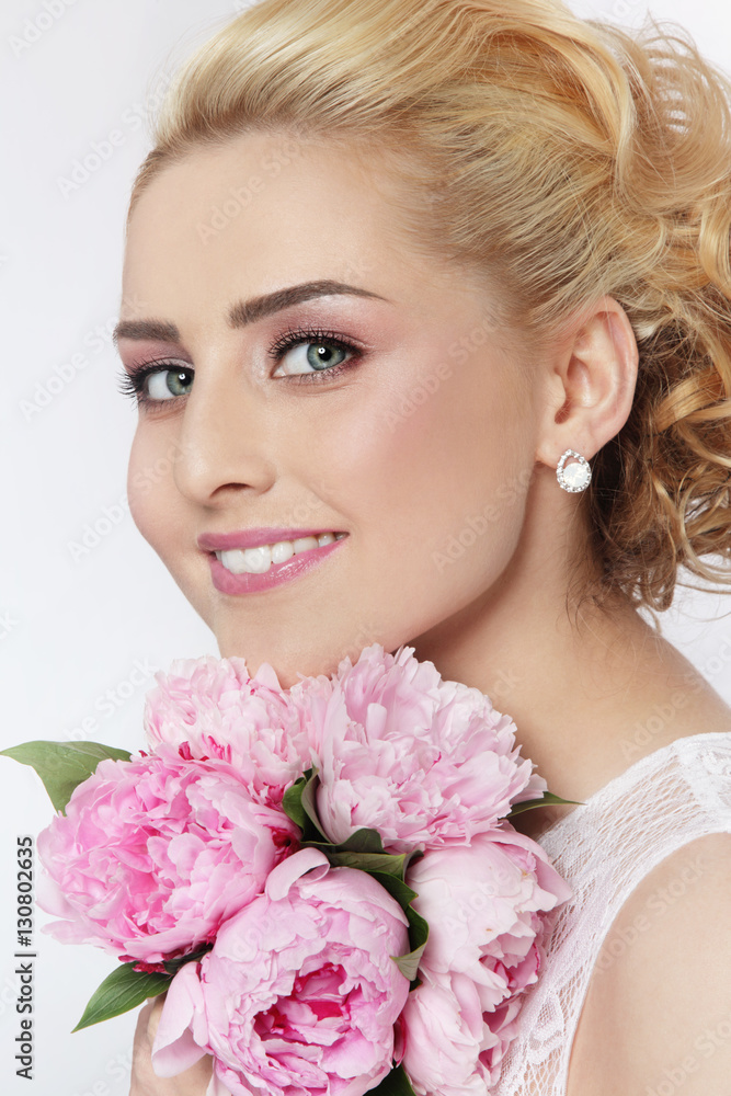 Portrait of young beautiful blonde happy smiling bride with bouquet 