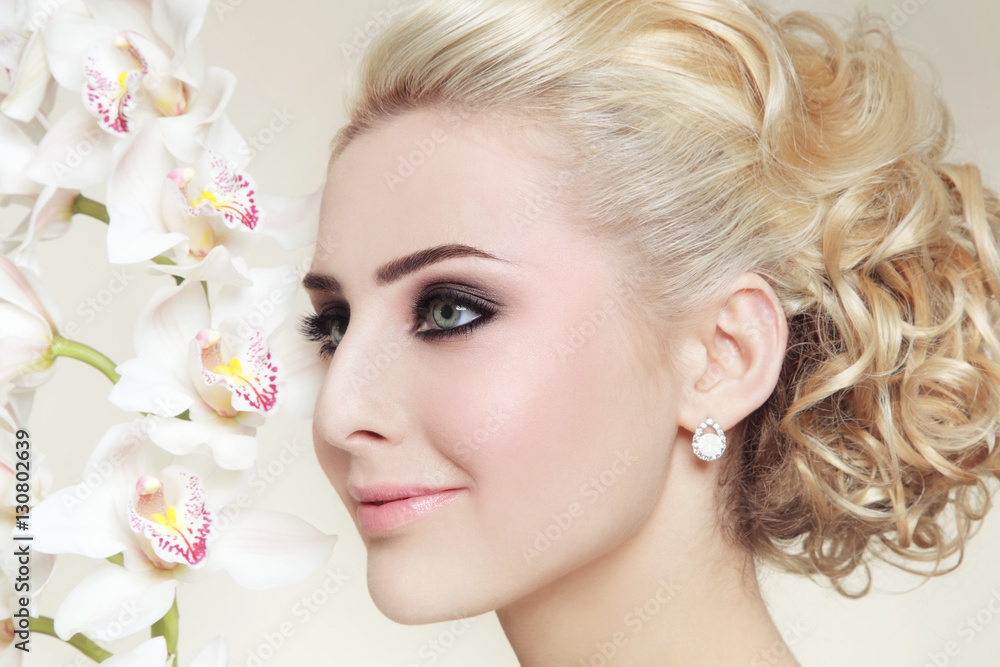 Close-up portrait of young beautiful blond girl with smoky eyes and stylish prom hairdo Close-up portrait of young beautiful blond girl with smoky eyes and stylish prom hairdo