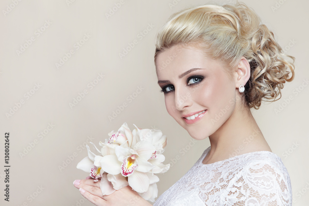 Young beautiful happy smiling bride with stylish make-up and hairdo