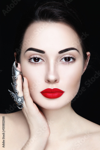Young beautiful woman with red lipstick and fancy clow ring on her finger