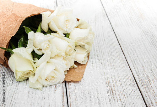 White roses on a wooden table