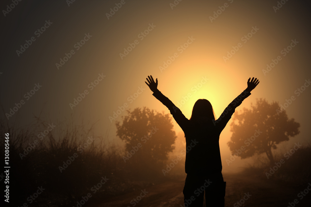 Silhouette of Freedom traveler women standing with raised arms a Silhouette of Freedom traveler women standing with raised arms a