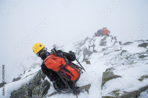 Alpinists in mountains. Team work.