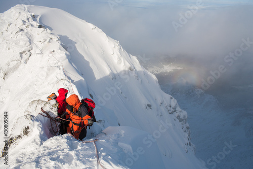 Mountaineering. Teamwork in alpinism. Traverse of mountain.