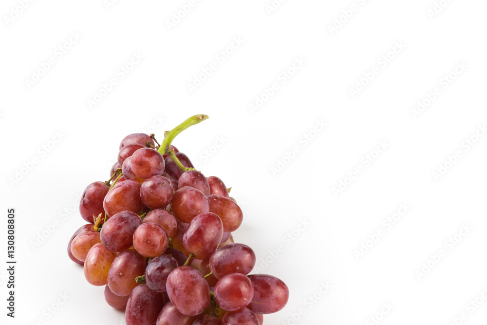 Fototapeta premium Fresh purple grapes on a white background