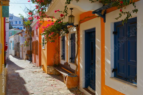 Colorful architecture in a street of Halki village, Greece. © milangonda
