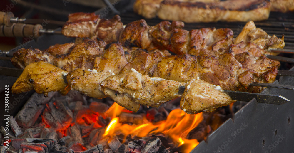 deep fried skewers on the grill, with coals