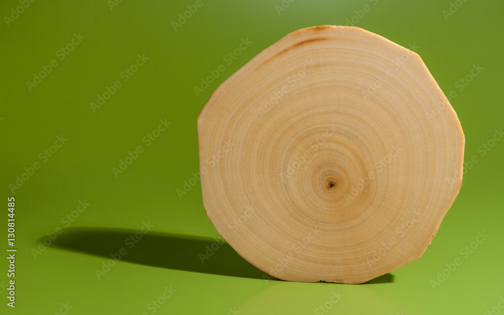One polished and oiled alder saw cut on green background. One polished and oiled alder saw cut on green background.