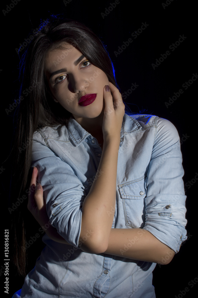 Young woman ,studio portrait on black background Young woman ,studio portrait on black background