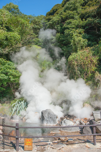 Hot Spring water boiling from stone ground, Beppu, Oita, Japan, Japanese language in placard paper means " 90 degree hot warning". 