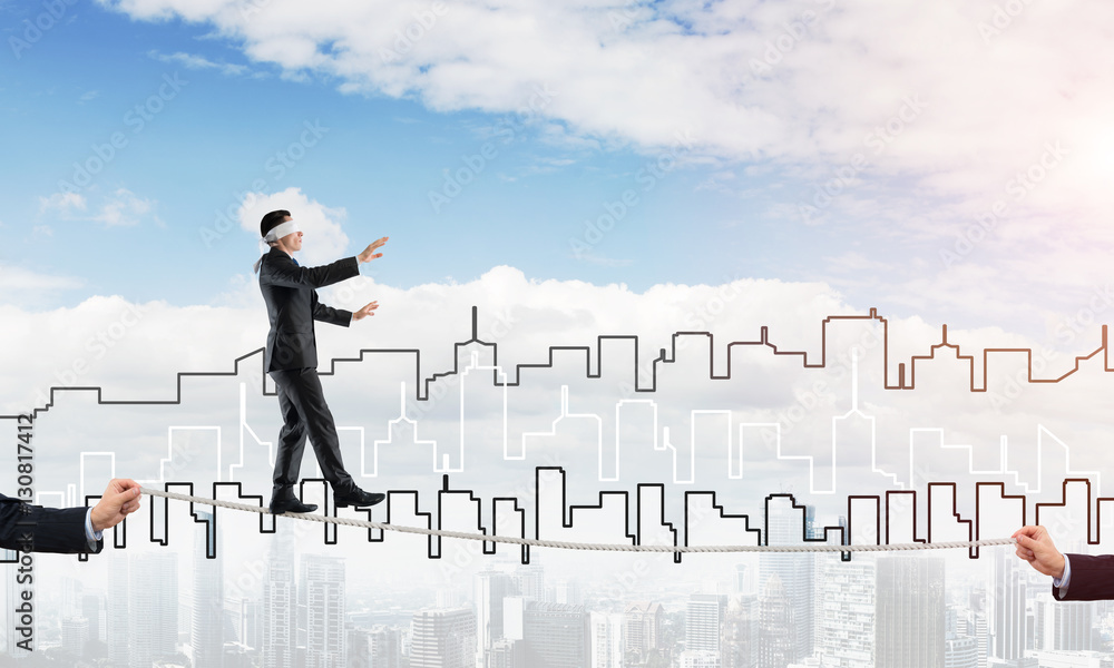 Business concept of risk support and assistance with man balancing on rope Business concept of risk support and assistance with man balancing on rope