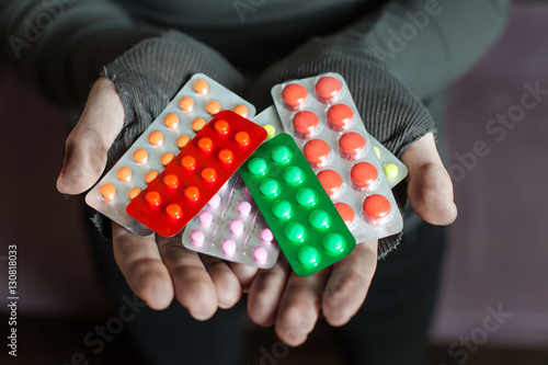 Obraz na plátně Male hands is holding a lot of different tablets.