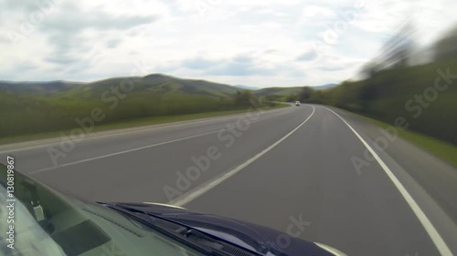 Driving on the highway in the mountains. Point of view camera filming. Time lapse.