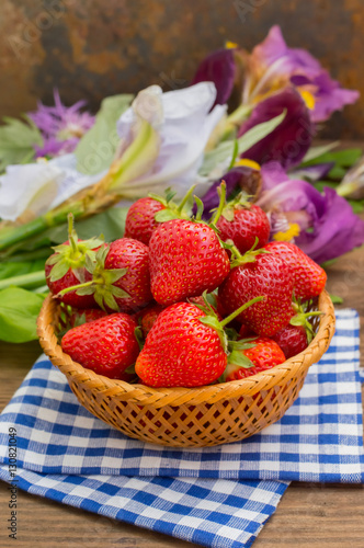 Strawberries in the basket on wooden background