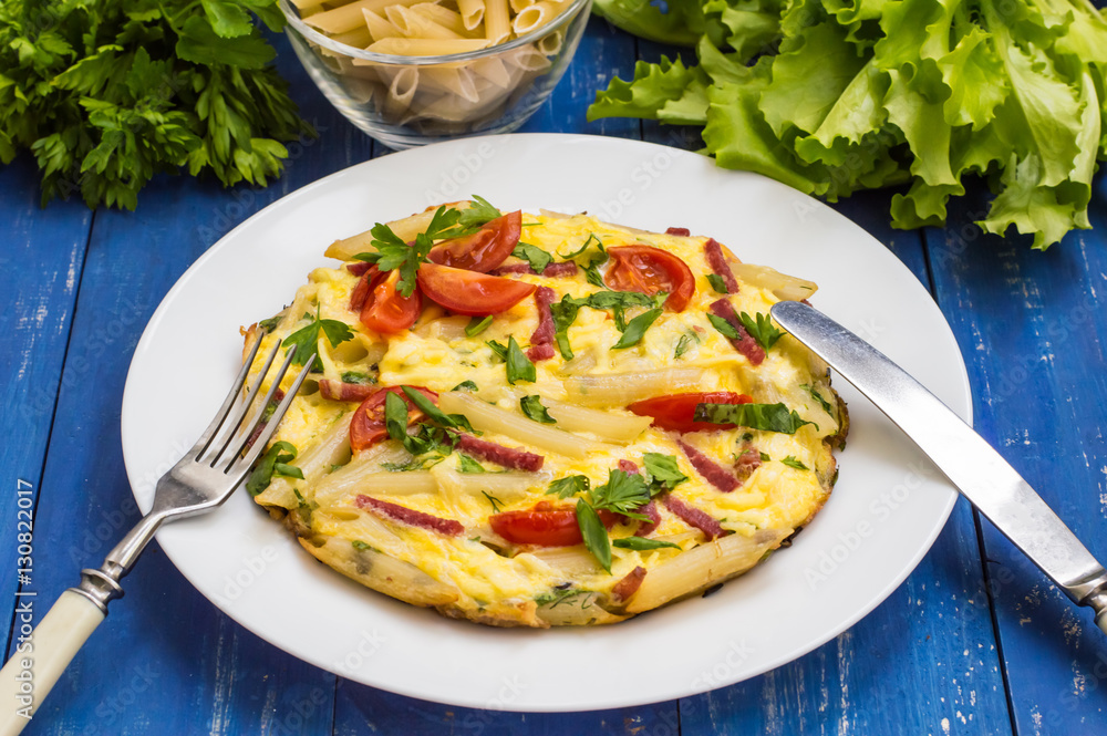 Frittata in Italian on a wooden table. Top view. Close-up Frittata in Italian on a wooden table. Top view. Close-up