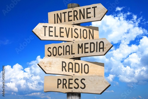 Wooden signpost - media concept (Internet, television, social media, radio, press). photo