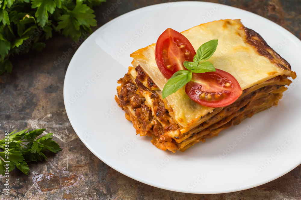 Lasagna, traditional Italian food on a wooden background Lasagna, traditional Italian food on a wooden background