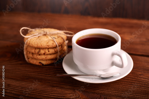 Coffee and Homemade cookies with chocolate. Handmade Chocolate cookies and cup of espresso on wooden table. Pile of delicious chip cookies. Christmas cookies. Biscuits. Oat biscuits.