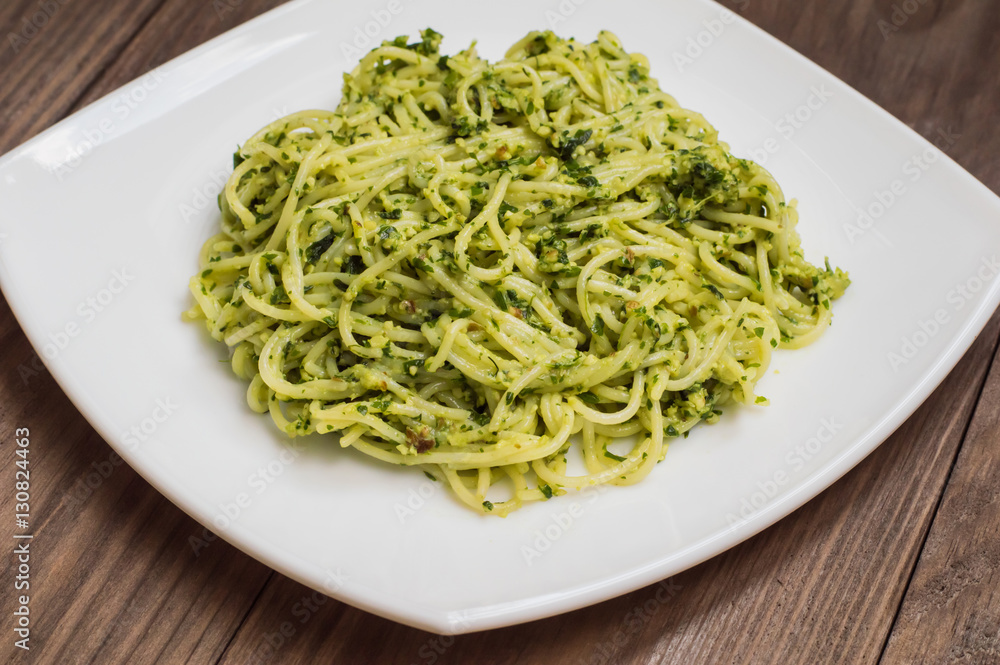 Pasta with pesto Brazilian. Wooden table. Top view Pasta with pesto Brazilian. Wooden table. Top view