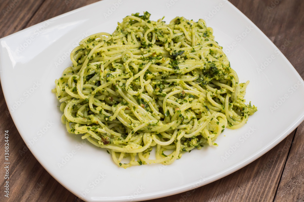 Pasta with pesto Brazilian. Wooden table. Top view