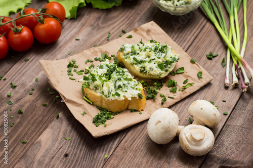Sandwich of cheese with herbs. Wooden background. Top view