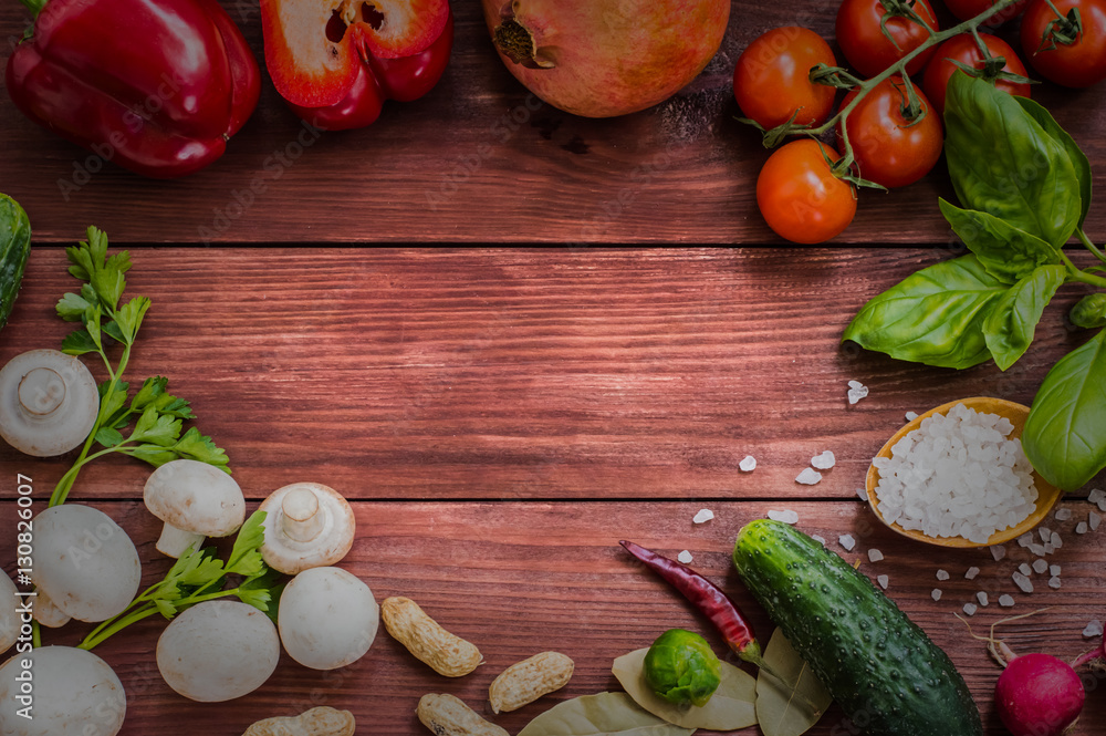 Set of vegetables, herbs and spices for salad. Wooden background. Top view Set of vegetables, herbs and spices for salad. Wooden background. Top view