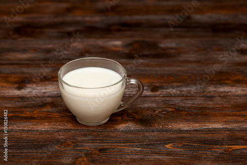 Cup of milk on rustic wooden table