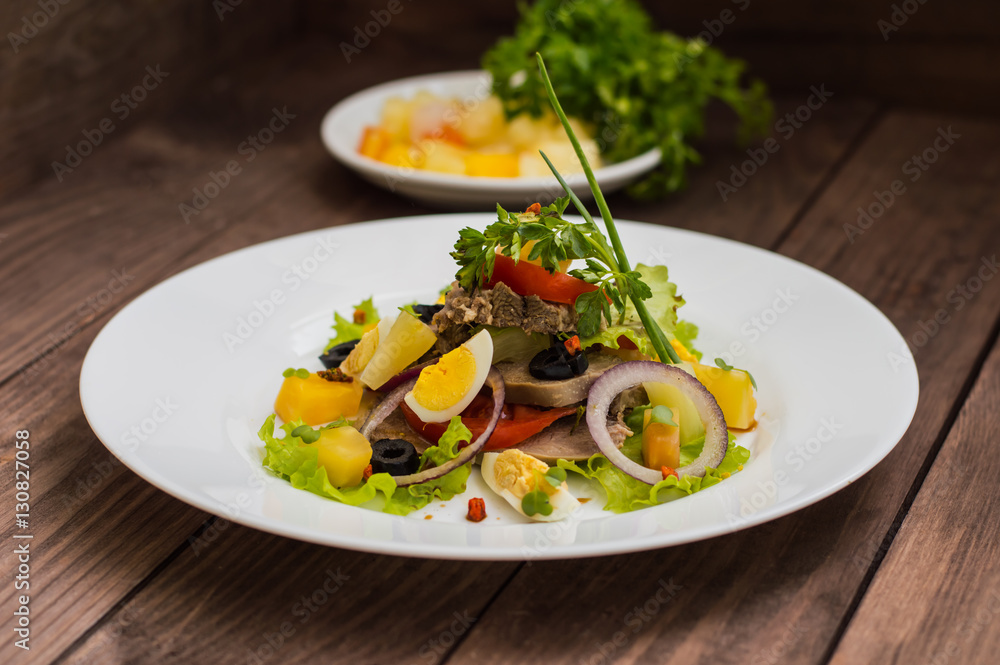 Salad with tongue on the wooden background Salad with tongue on the wooden background