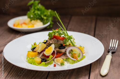 Salad with tongue on the wooden background