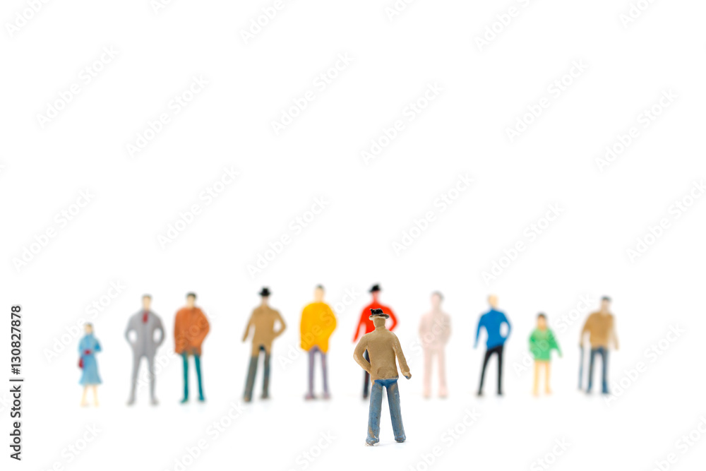 Group of miniature people standing on white background Group of miniature people standing on white background
