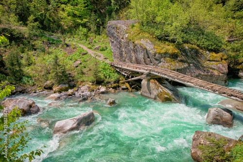 Fototapeta Naklejka Na Ścianę i Meble -  wooden bridge over the mountain river 