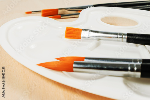 Wallpaper Mural White art palette with brushes on wooden background Torontodigital.ca