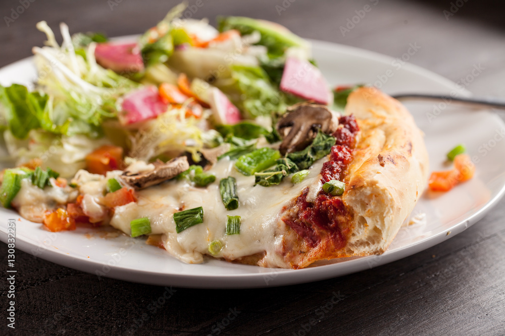 Home made pizza from scratch topped with mushrooms, turkey, kale, peppers, and tomatoes macro shot Home made pizza from scratch topped with mushrooms, turkey, kale, peppers, and tomatoes macro shot
