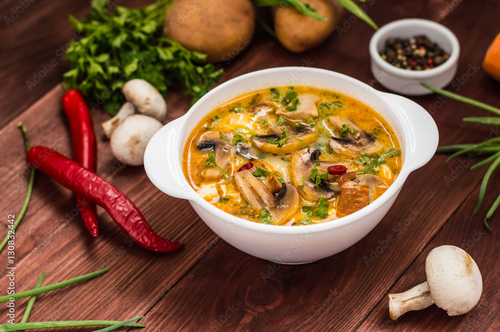 Delicious soup with smoked chicken, mushrooms, eggs and cream. Wooden background