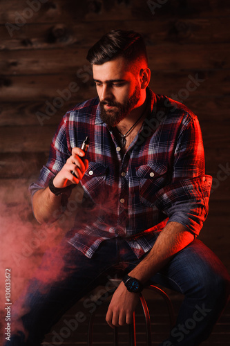 Brutal man smoking electronic cigarette