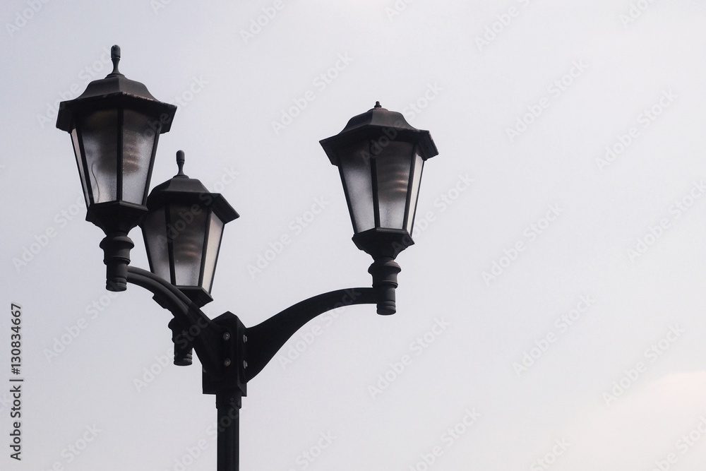 3 ways electric lamp post againt clear blue sky