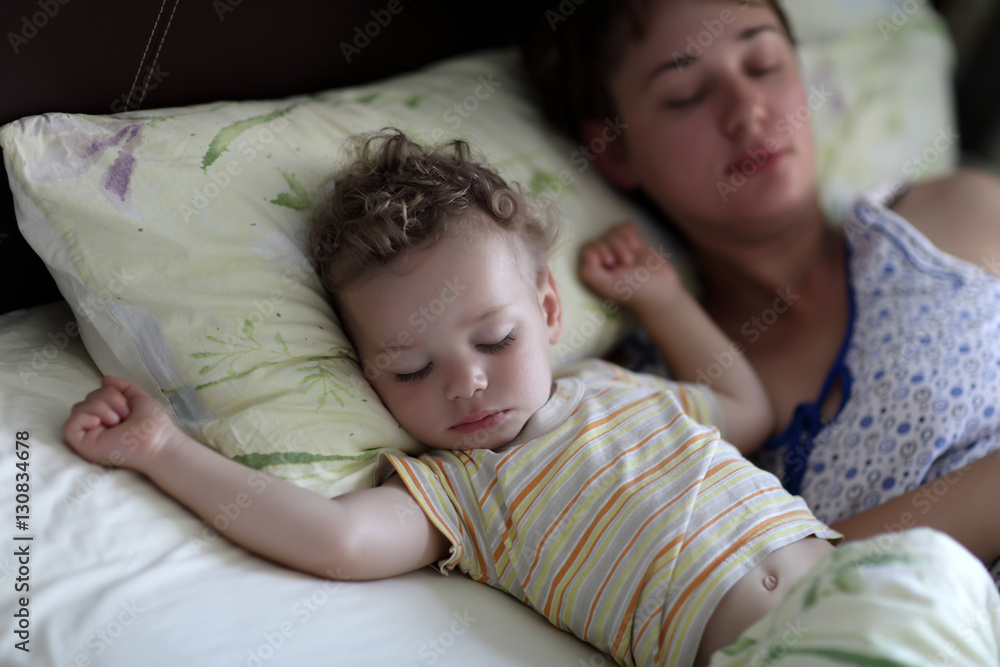 Mother with toddler on a bed Mother with toddler on a bed
