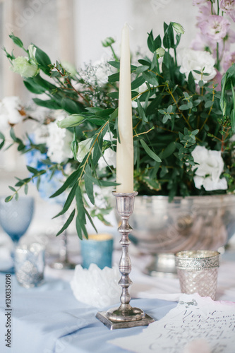 Silver candlestick as element of festive table wedding centerpieces decorations.