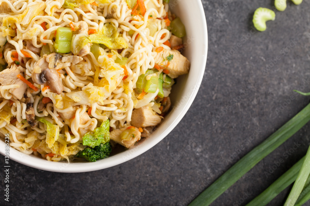Chinese chicken lo mein with cabbage, carrots, celery, mushrooms, turnips, broccoli, and