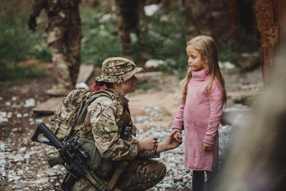 Soldier and children on battlefield background.