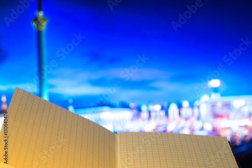 notebook on the background of the city at night photo