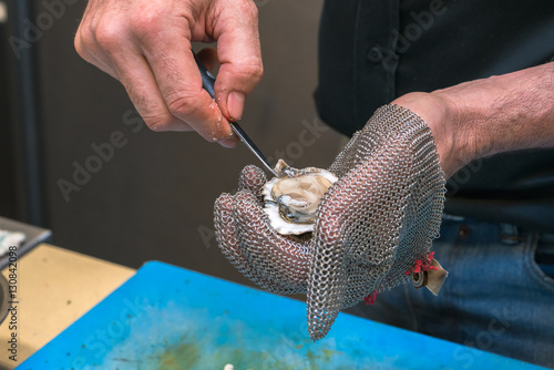 Принти на полотні Fresh oyster held open with a oyster knife