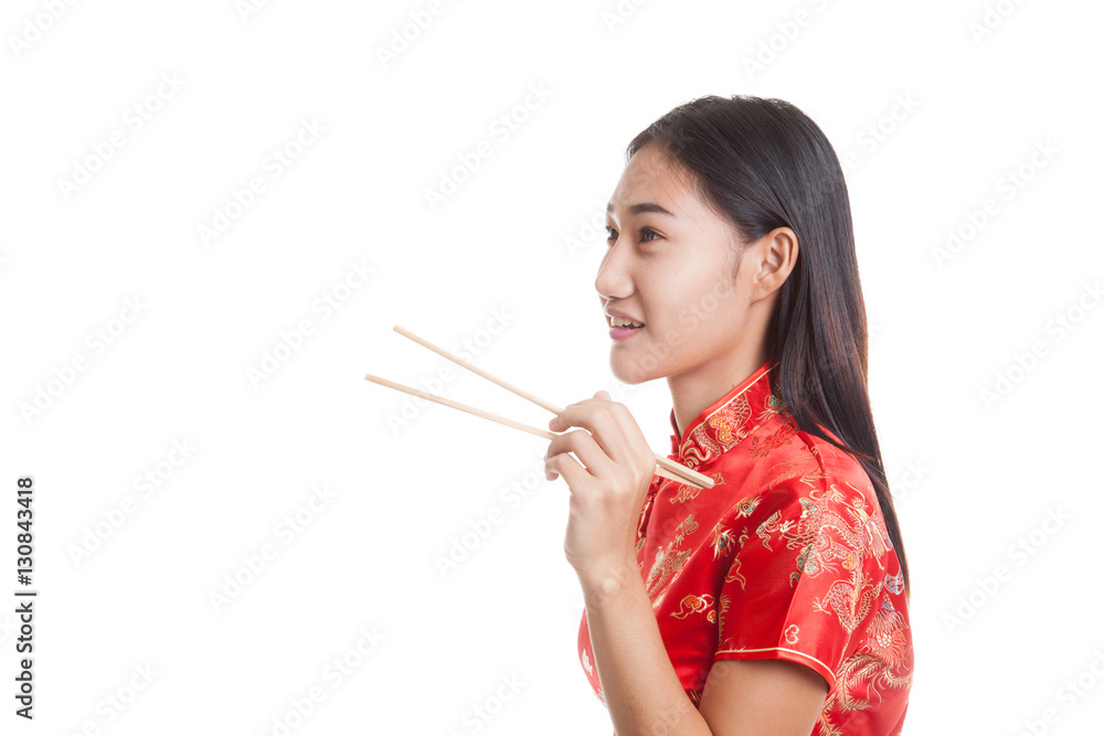 Asian girl in chinese cheongsam dress with chopsticks. Asian girl in chinese cheongsam dress with chopsticks.
