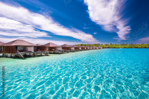 Luxurious over-water bungalows in beautiful lagoon on tropical island
