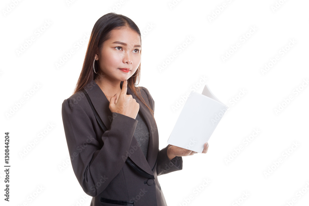 Young Asian business woman with a book is thinking. Young Asian business woman with a book is thinking.