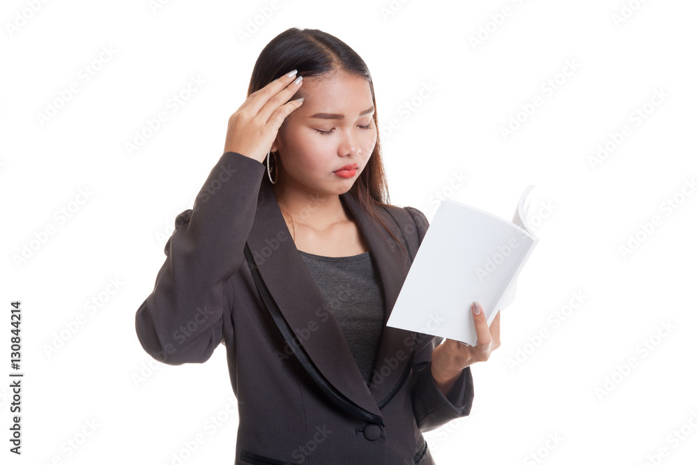Young Asian business woman got headache read a book. Young Asian business woman got headache read a book.