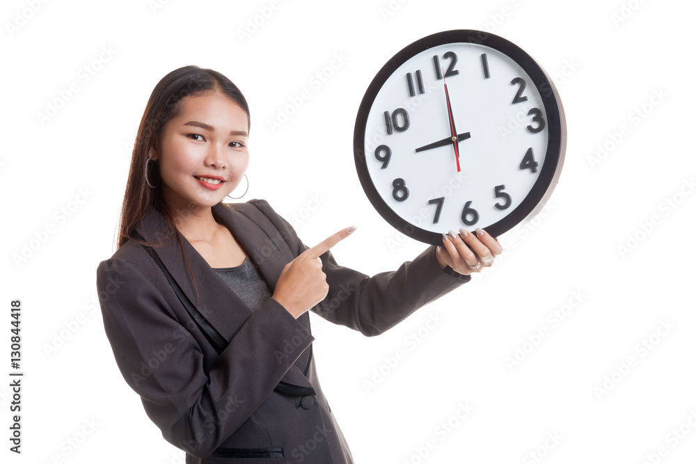 Young Asian business woman point to a clock. Young Asian business woman point to a clock.