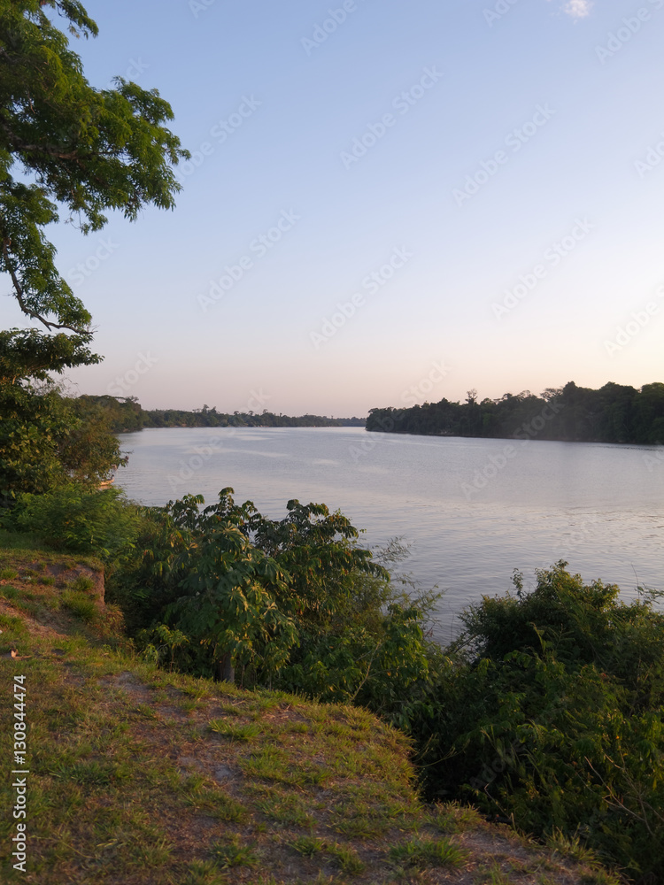 Le jour tombe sur le fleuve Maroni vu des  rives du village de Grand-Santi dans l'ouest de la Guyane française.