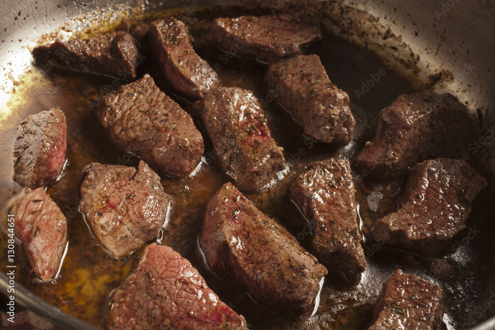 beef pieces browning in a pot beef pieces browning in a pot
